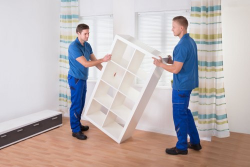 Movers navigating stairs during a Dulwich flat removal